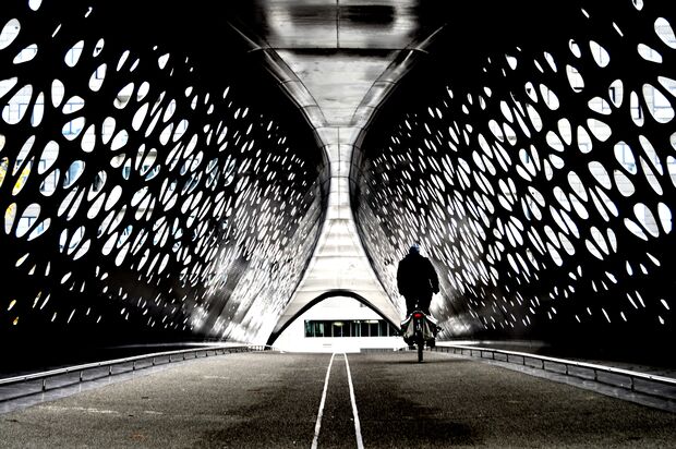 Cyclist crossing a tunnel bridge