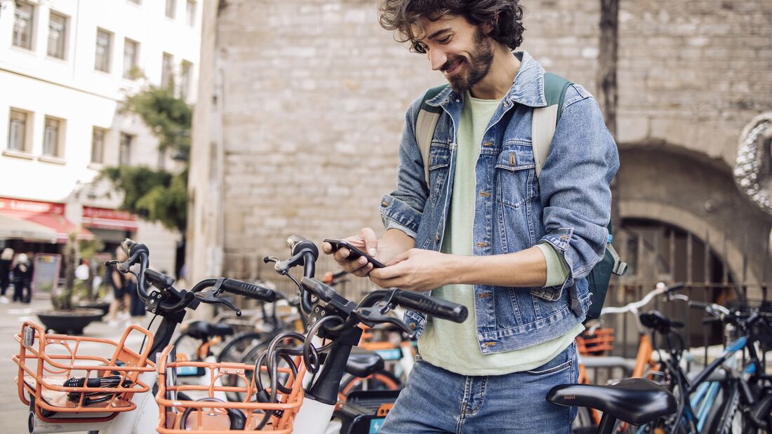 Young tourist renting an e-bike to explore Barcelona